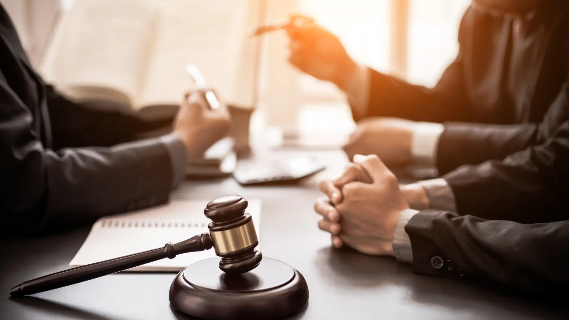 A lawyer and judge at a table, featuring a gavel, symbolizing a legal discussion or court proceeding